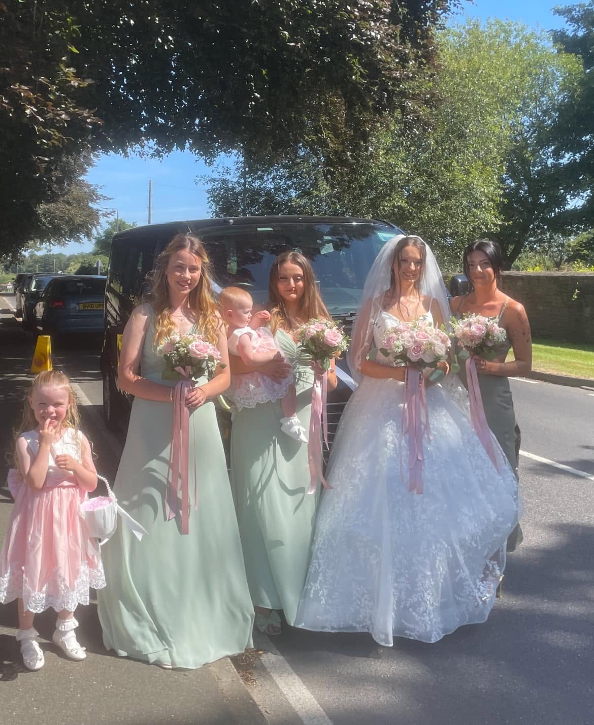 Bride and bridesmaids beside our 8-seater on a summer wedding day